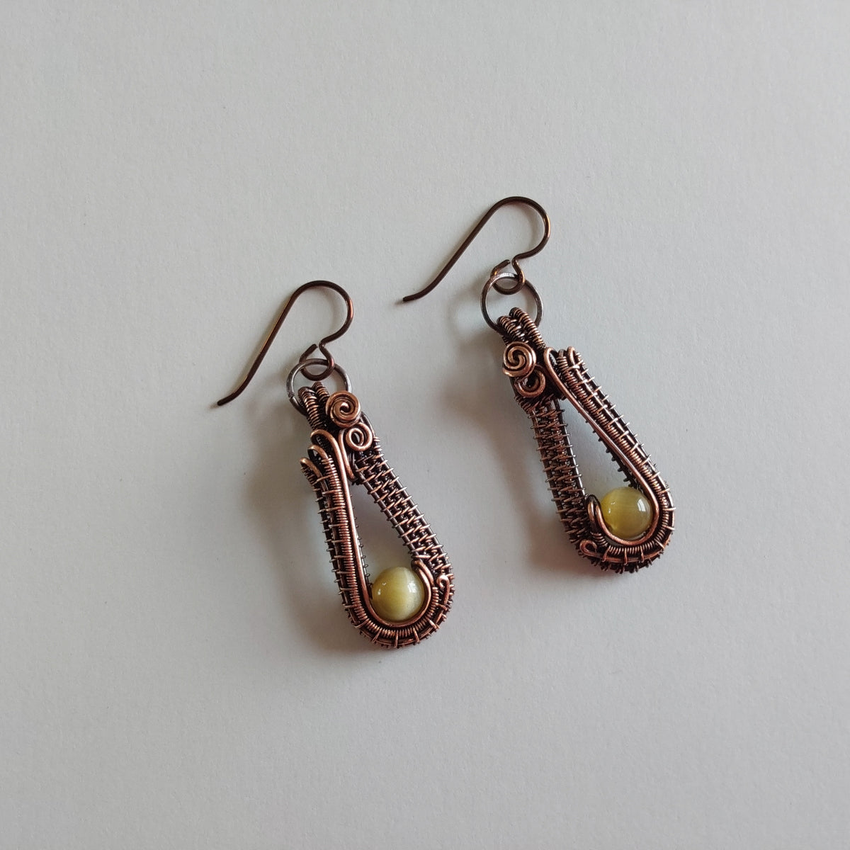 Handmade wire weave Cats Eye earrings in copper.