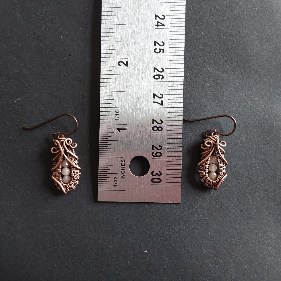 Faceted Peach Moonstone 'Ballet Shoe' style earrings with hypoallergenic ear wires. The wire weave component of each earring is approximately 1/2 an inch (2cm) in length plus ear wire length of 2 cm.