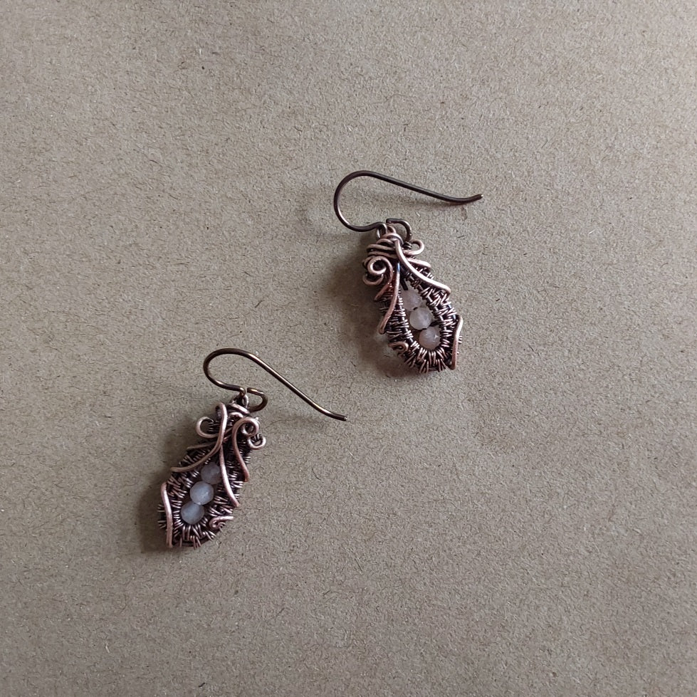 Faceted Peach Moonstone 'Ballet Shoe' style earrings with hypoallergenic ear wires. The wire weave component of each earring is approximately 1/2 an inch (2cm) in length plus ear wire length of 2 cm.