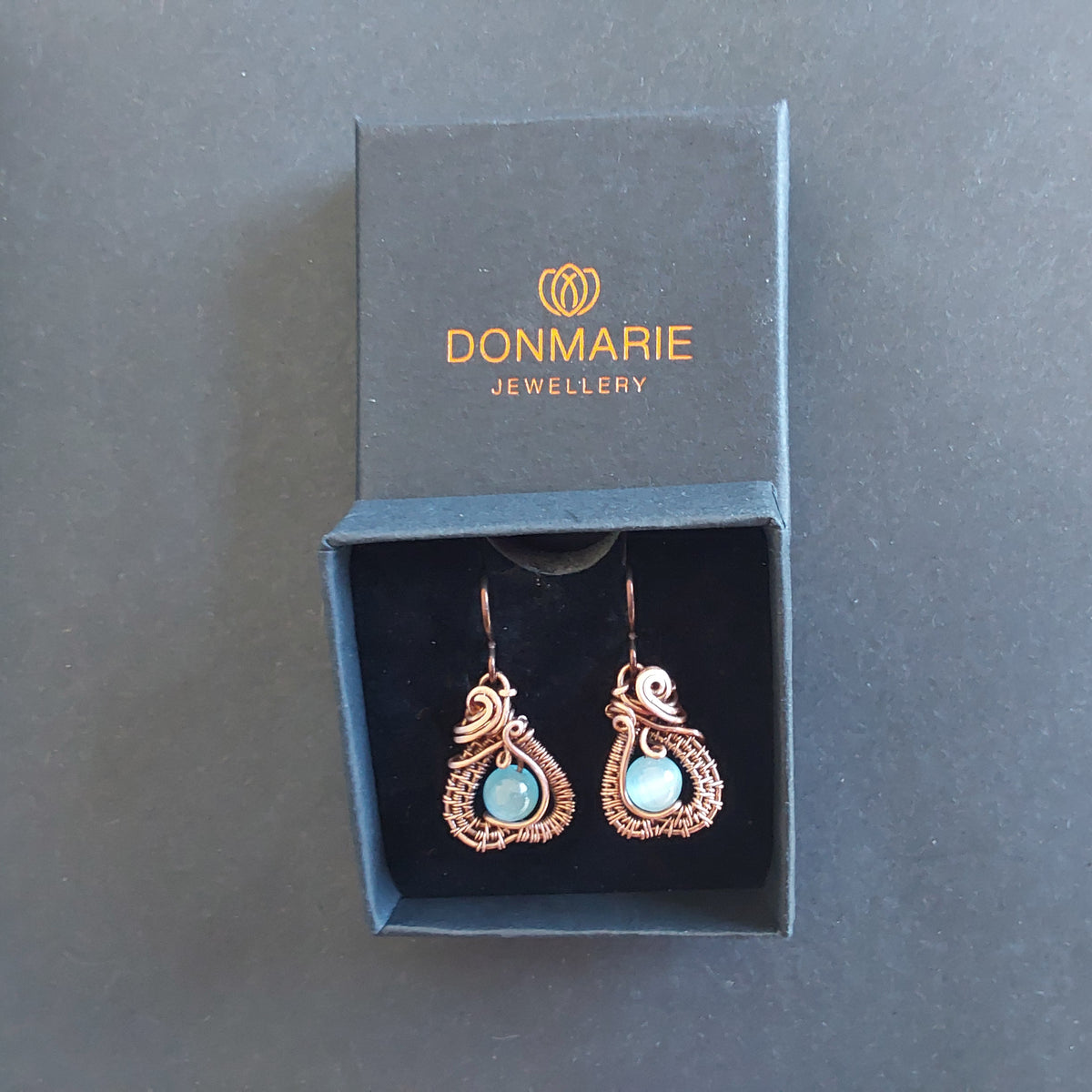 Intricate wire weave earrings with Blue Cats Eye beads